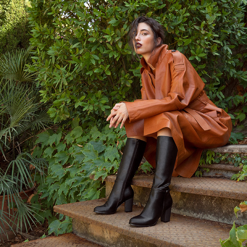 Heeled boots in black faux leather with buckled strap detail 