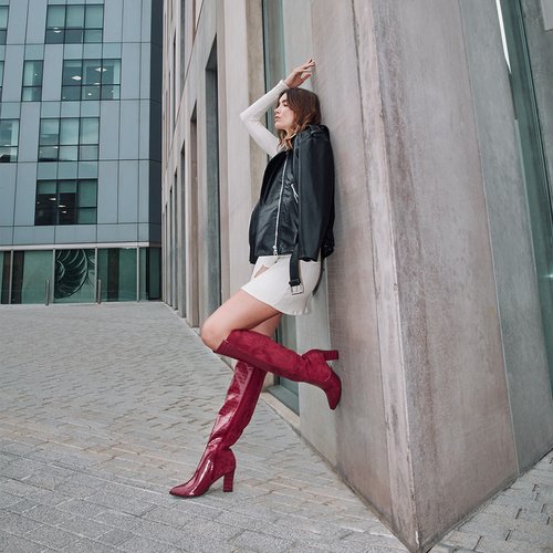 Heeled knee-high boots combined green faux croc leather with faux suede. 